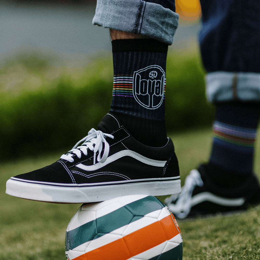 Custom Mid socks with a blue leaf design, worn with running shoes